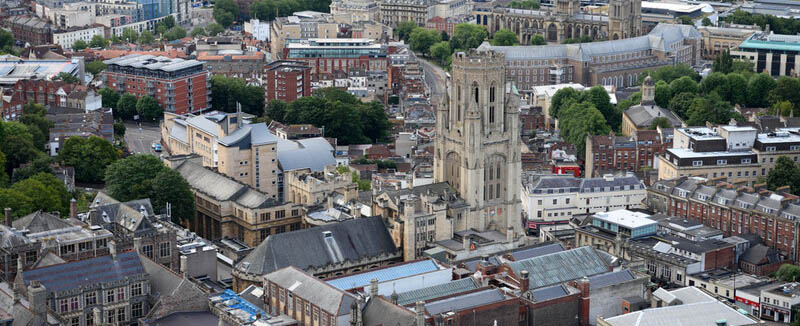 an aerial shot of the city with the wills building in the centre and the cathedral beyond