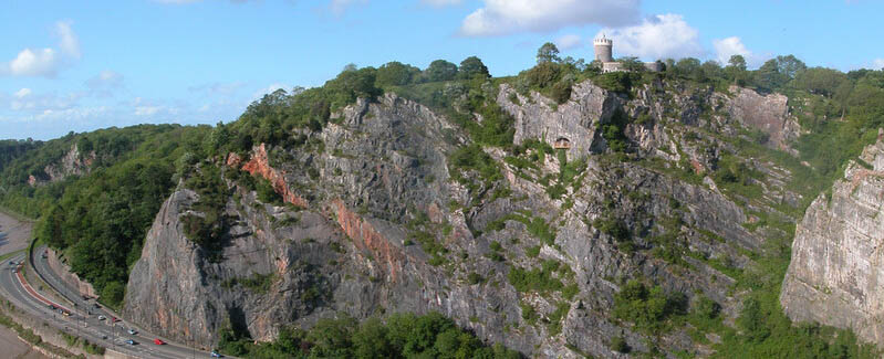 A side on image of the observatory side of the avon gorge with a main road curving round the base of the cliffside.