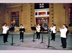 The London Philharmonic Brass Ensemble performs outside the Victoria Rooms 