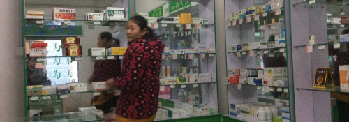 A woman stands in a pharmacy 
