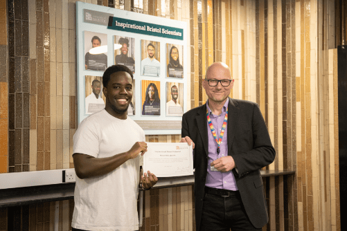 Photo of Shaun Olok-Jacobs being presented with his certificate by Dean of Science, Jens Marklof.