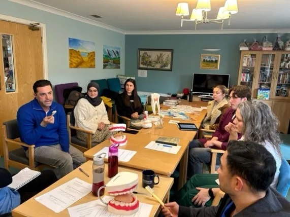 A picture of students training carers in oral health.