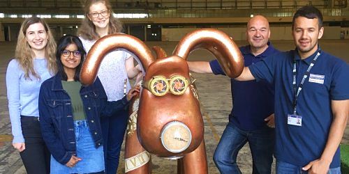 Group of students and technical staff with a Gromit model