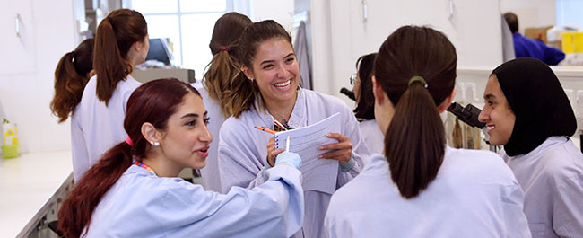 Group of students in a laboratory.	