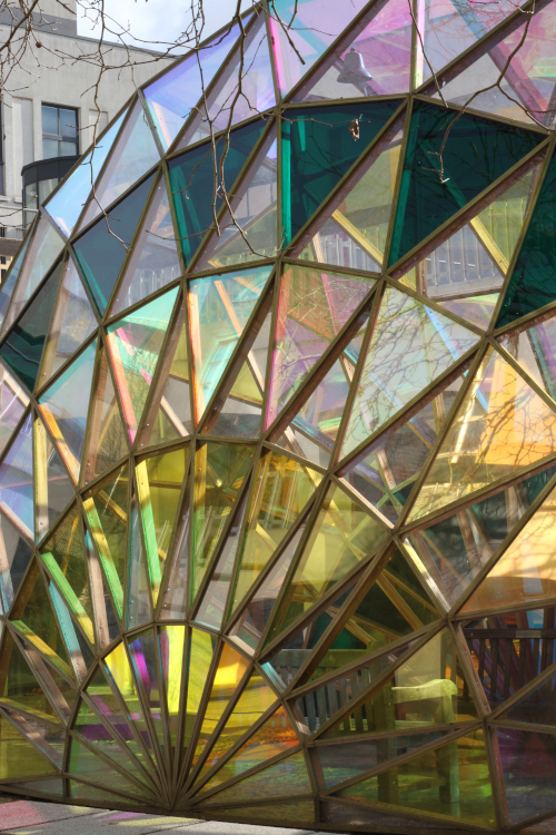 Colourful large glass semi circle sculpture outside the university's chemistry building.