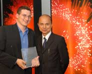 Edward Moline (left) receives his award from shoe designer, Jimmy Choo