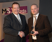 From left to right: Pianist, Bobby Crush, presents Laurence Ketteringham with the 'MS Researcher of the Year’ award.