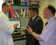 Dr Pat Kehoe (Bristol University) explains to Neil McDonald of Bunzl Healthcare (centre) and Mark Poarch of BRACE why the BioAnalyser is an invaluable tool