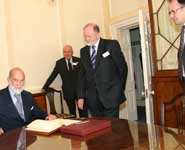 HRH Prince Michael of Kent signing the University's visitors' book with [from left to right] Colonel Sam Gaussen, Director of NERC, Professor David Clarke, Deputy Vice-Chancellor and Andrew Dick, Professor of Ophthalmology