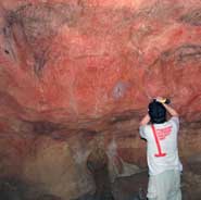 Project lead Dr Alistair Pike removing thin calcite crusts for dating from paintings on the Main Panel in Tito Bustillo Cave, Asturias, Spain