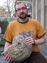 Dr Kenneth De Baets holding a full-grown manticoceratid (Manticoceras) from the Late Devonian of Morocco, one of the largest known ammonoids from this time