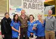 Luke (centre) with Head of School Jo Price (left) and staff and students outside the Mission Rabies truck