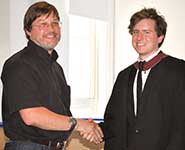 Glenn Farrall from Infineon presenting Mike O’Connor from the Department of Computer Science with his prize awarded for the best student project in computer architecture