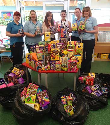 Emily Brasher, Kayleigh Knowlson with nurses from Bristol Children’s Hospital and donated Easter eggs