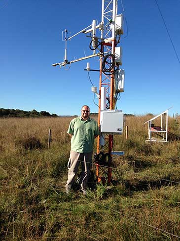 Image of Dr Rosolem with the cosmic-ray soil moisture sensor installed at the the Federal University of Santa Maria SulFlux site in Brazil 