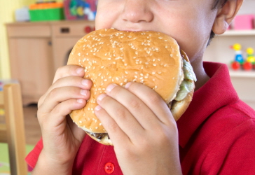 Kid eating burger at school
