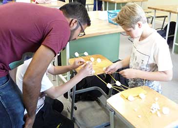 PhD student supervising bridge-building activity