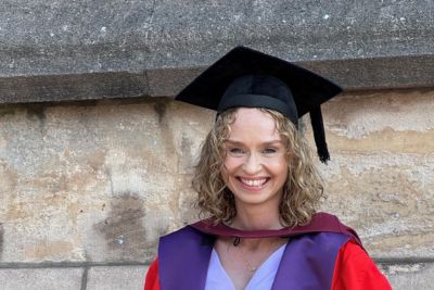 Head shot of Mel de Lange at her PhD graduation outside the Wills Memorial Building