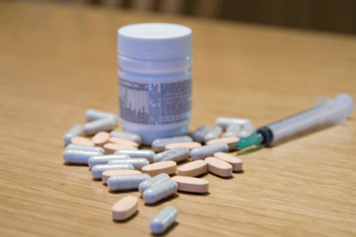 Generic image of a syringe and bottle of tablets