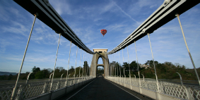 The Clifton suspension bridge with hot air balloon above the road