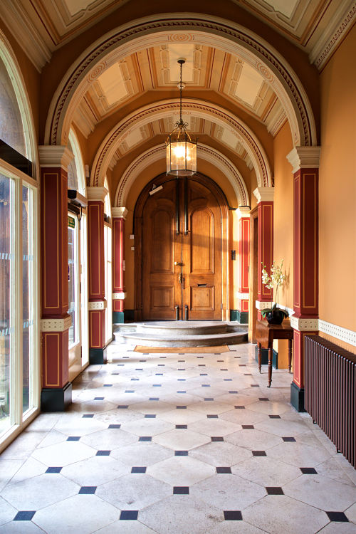 Entrance hallway to Goldney House with high arches and large windows