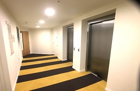 A hallway with two lifts.