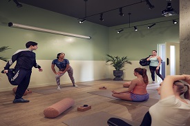 Five people of different races and genders do yoga poses in a studio room.