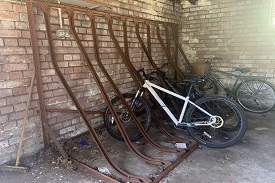 Bikes locked to a metal railing.