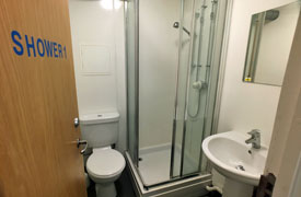 Shared bathroom with toilet, shower and sink