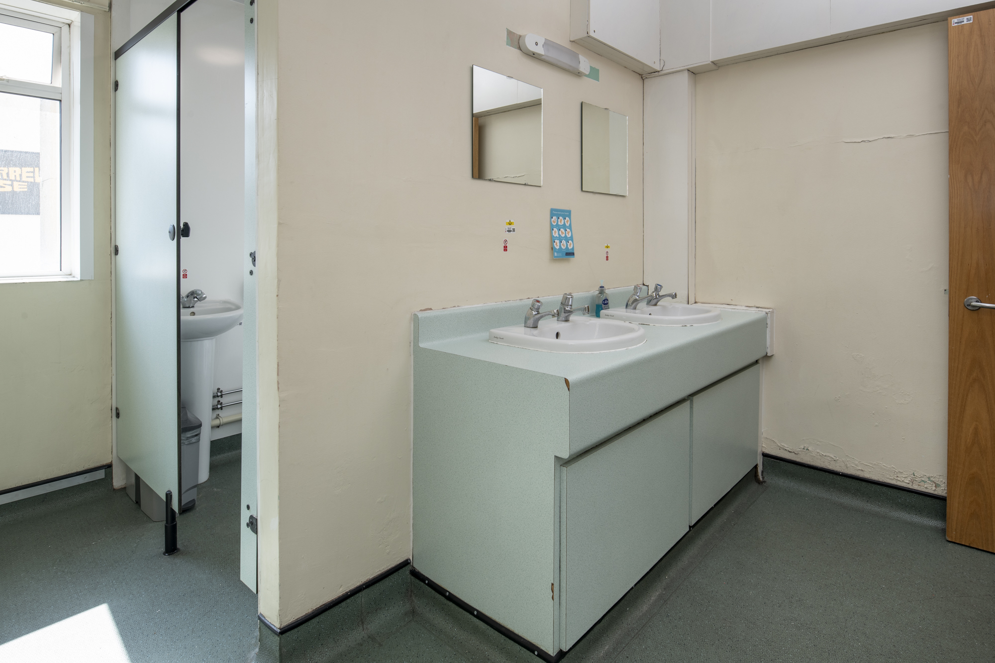 Shared bathroom with cubicle and two sinks