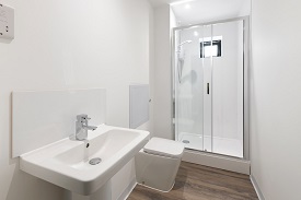 An en suite bathroom with a sink, toilet and shower.