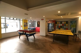 Social space showing table football game, table tennis table, vending machine, recycling bins and individual postboxes