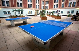 External social space in the courtyard, showing two table tennis tables