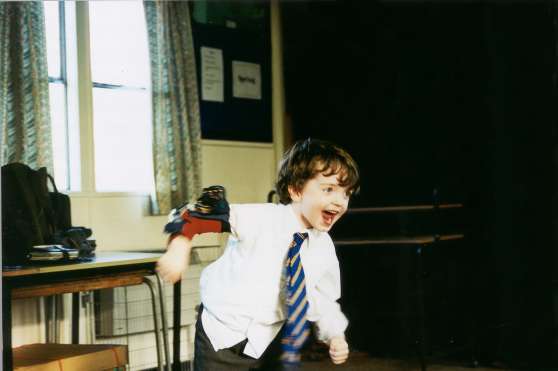Boy running, laughing and playing the wireless bend sensor (on his right elbow)
