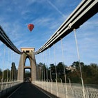 The Bristol Suspension Bridge with a hot air balloon flying over.