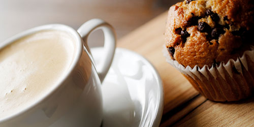 A cup of coffee and a muffin.