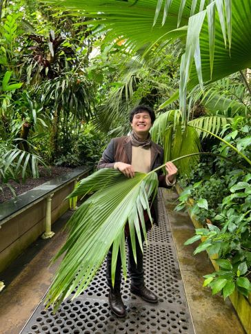 MScR student Nathanael Tan inside a green house in Kew Gardens