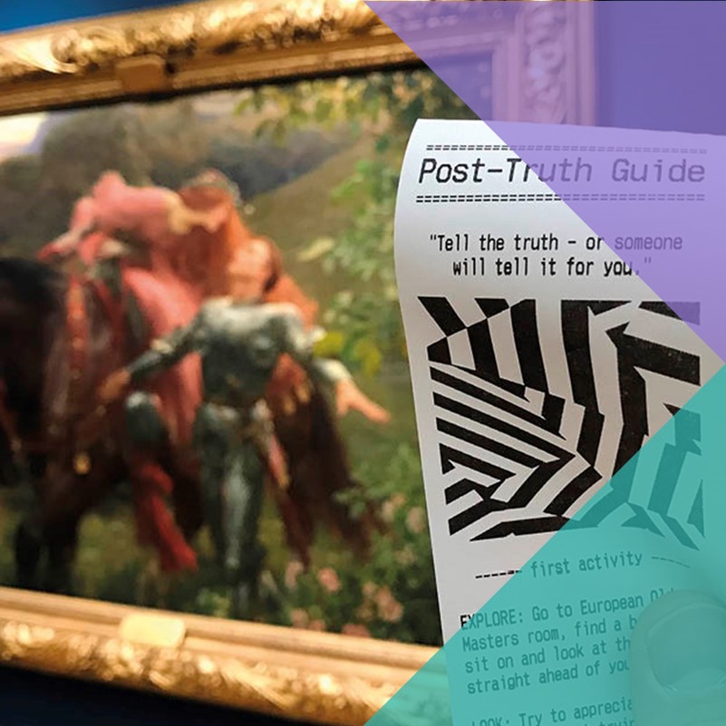A person holding a 'Post-Truth Guide' activity ticket in the foreground with a blurred painting in the background