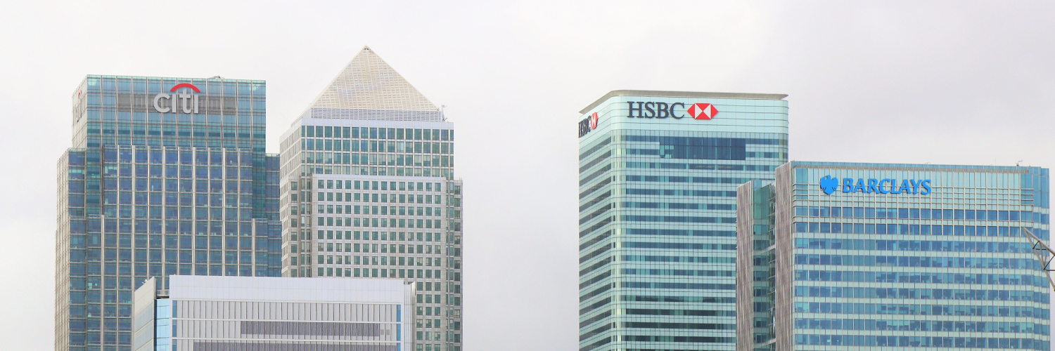 The skyline of the financial sector of a city, including a building with the HSBC logo on the side