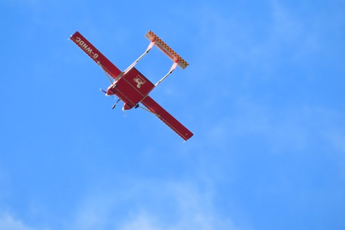 Flying drone against blue sky