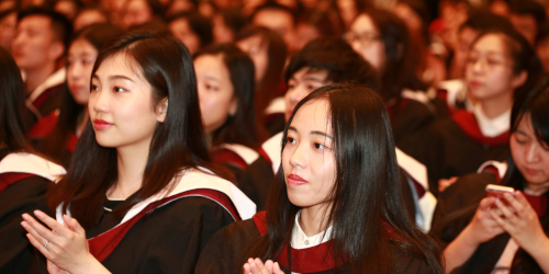 Two University of Bristol alumni sitting in the crowd at the China Graduation Ceremony