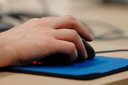 Close up of a hand using a computer mouse