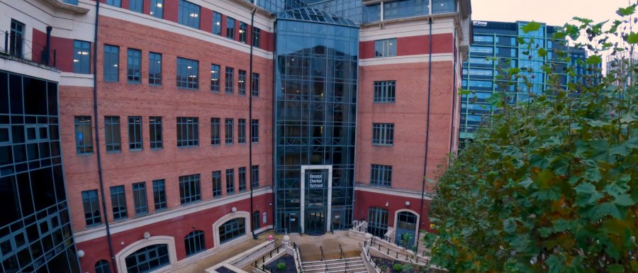 A view of the outside of the new Bristol Dental School building on Temple Quay, showing the main entrance and access paths.