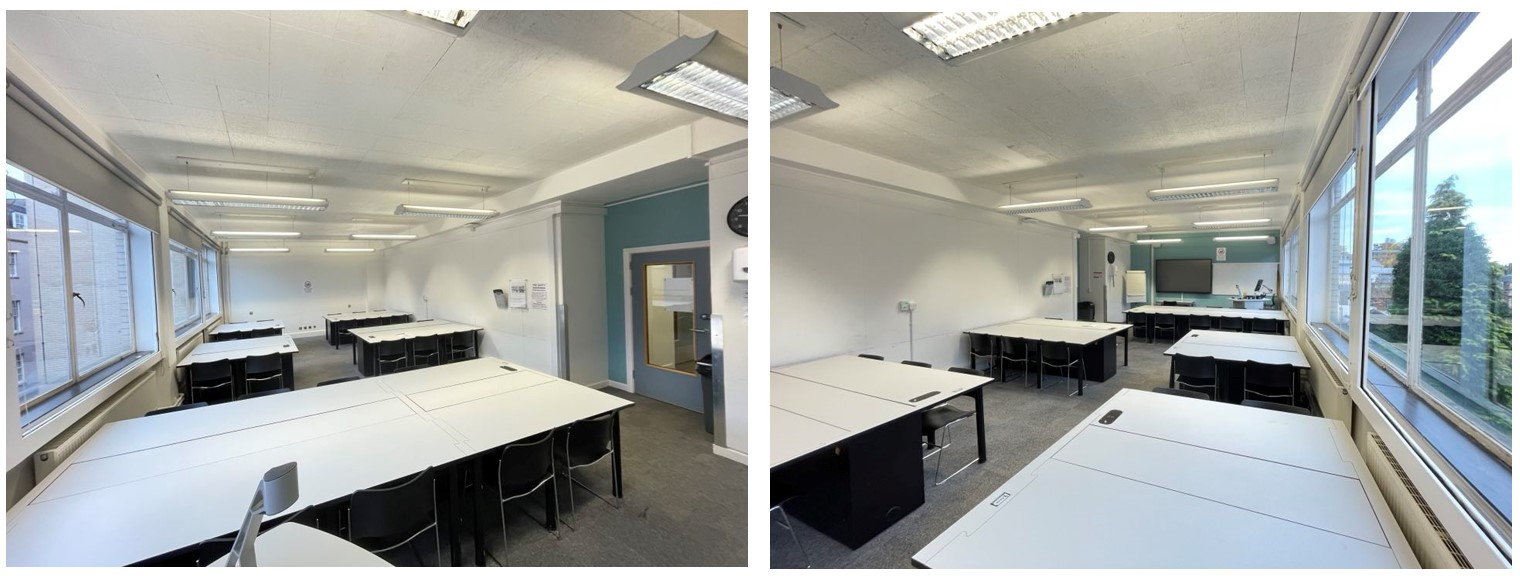 Chairs and PC tables in small groups around the room. The room has whiteboards fixed to the walls. The floor is carpeted.