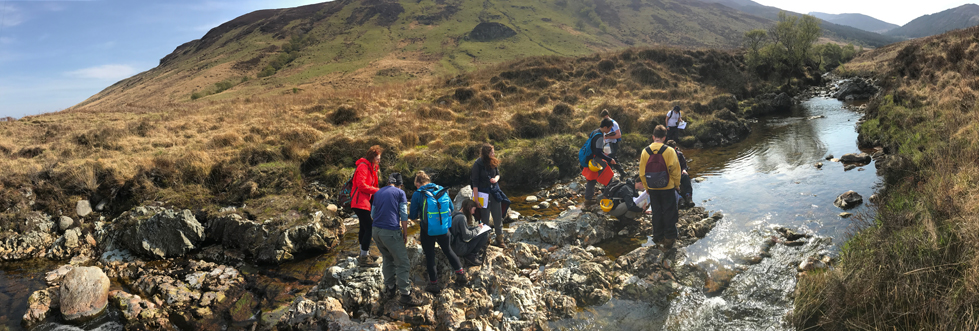 Students on a fieldtrip by a river on the Isle of Arran.