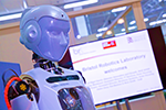 Humanoid robot with screen in background