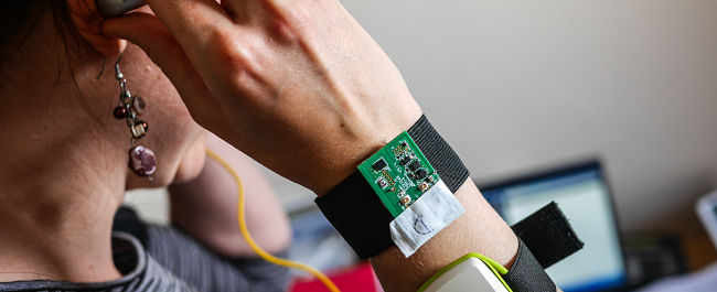 Woman with monitoring device on her wrist