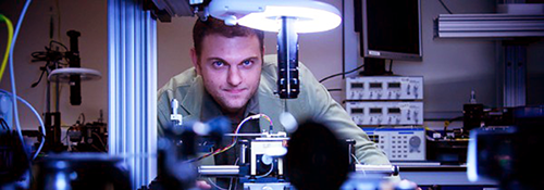 Male researcher in front of quantum equipment