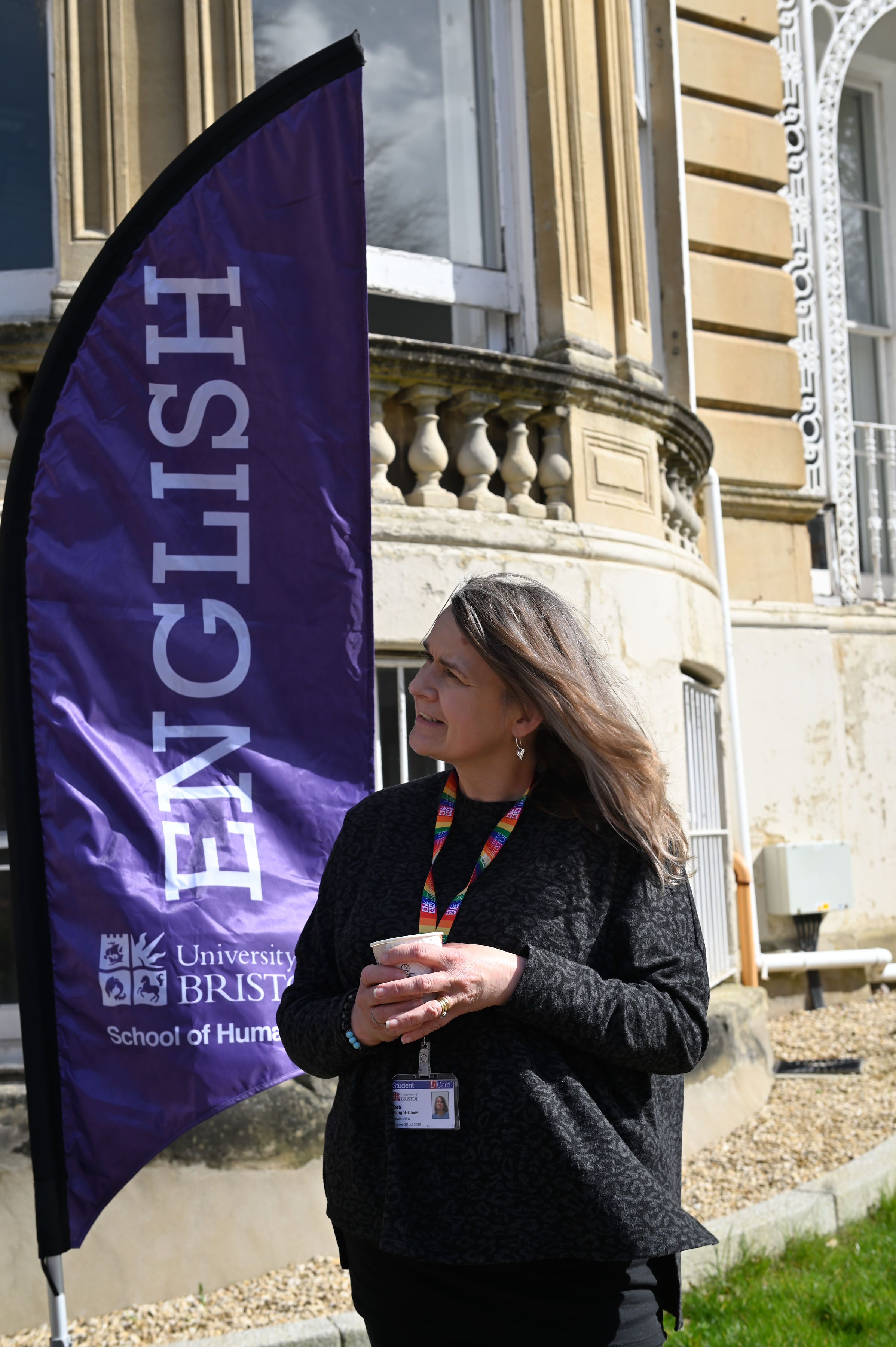 A white female student in her mid 50s stood next to a sign reading 'English'. 