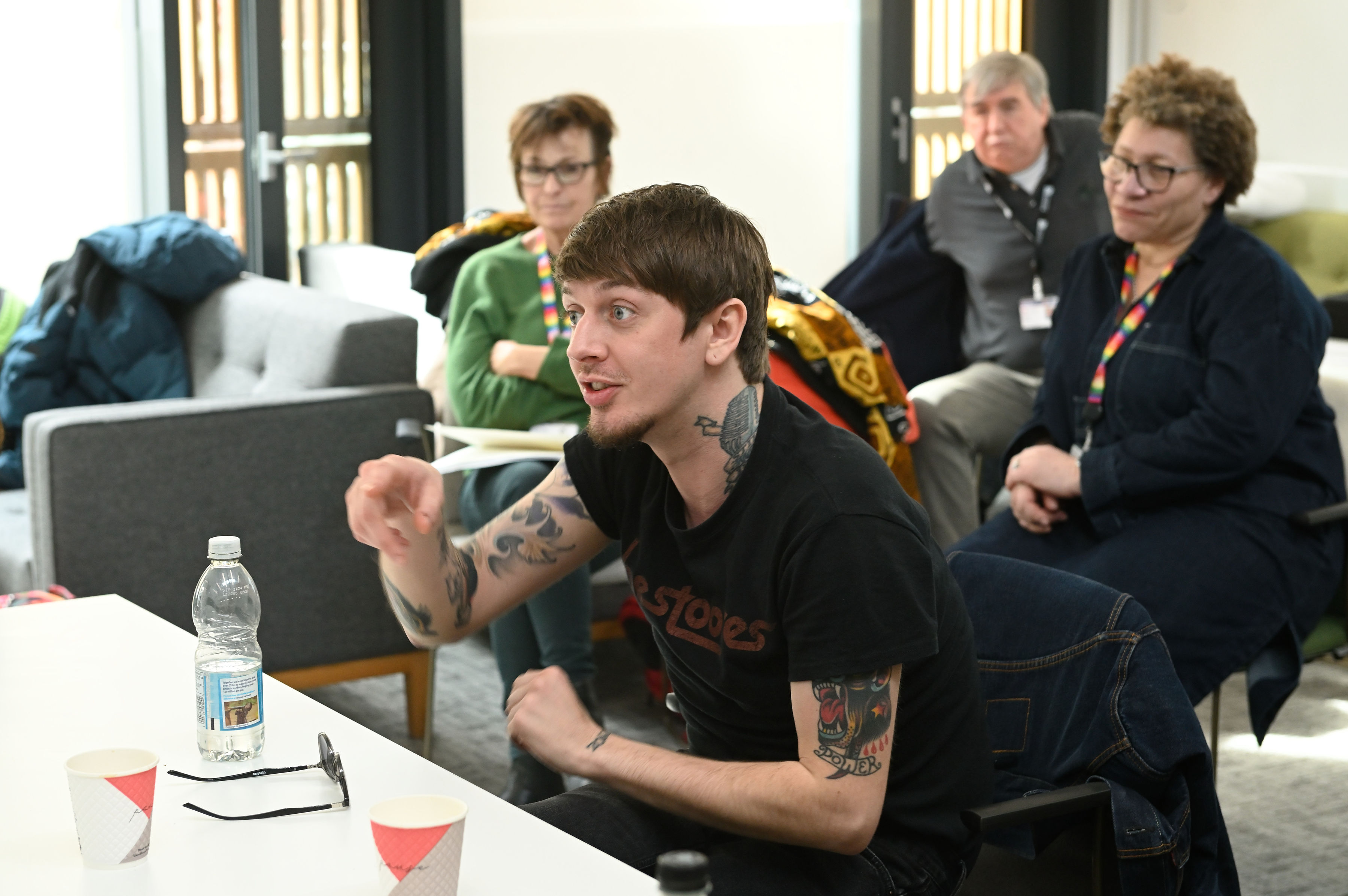 Mature students engaging in discussion in a classroom. 